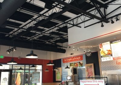 Garbanzos Mediterranean restaurant interior detail with black acoustic panels treatment on industrial white ceiling
