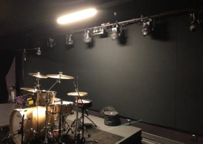 Washington's Fort Collins Venue Interior Detail showing black acoustic treatment stretched fabric panels on wall behind stage area