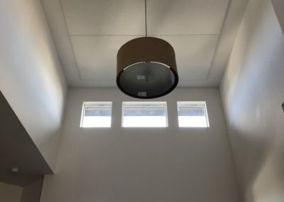 Home Interior with acoustic treatment stretched fabric on ceiling above front hallway entrance doorway with integrated lighting
