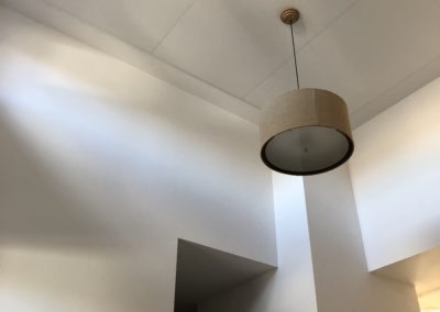 Home Interior with acoustic treatment stretched fabric on ceiling above front hallway entrance doorway with integrated lighting