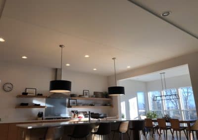 Home Interior with acoustic treatment stretched fabric on ceiling above kitchen bar counter with integrated lighting
