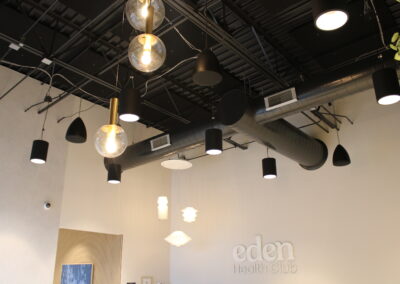 Edan Health Spa in Greenwood Village, Colorado showing ceiling pendant speaker installation and black acoustic ceiling panels